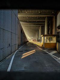 Empty footpath leading towards factory