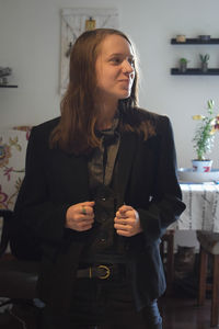 Young woman smiling while standing at home