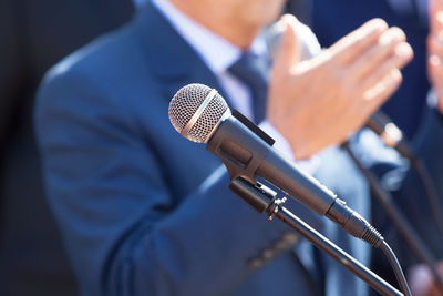 Midsection of man with microphone