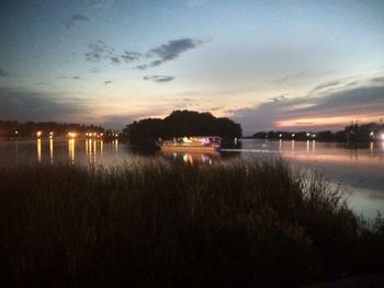 Scenic view of lake against sky at sunset