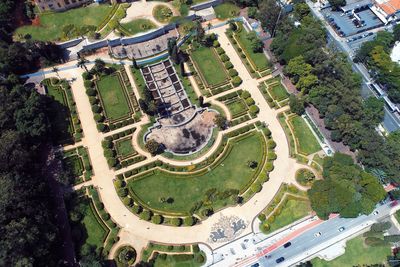 High angle view of trees and buildings on field