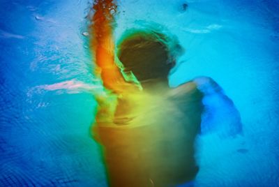 Blurred motion of woman swimming in pool