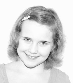 Close-up portrait of a smiling young woman over white background