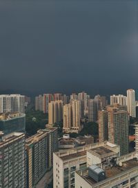 Buildings in city against clear blue sky