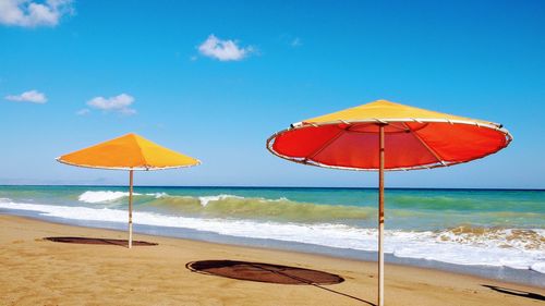 Umbrella on beach against sky