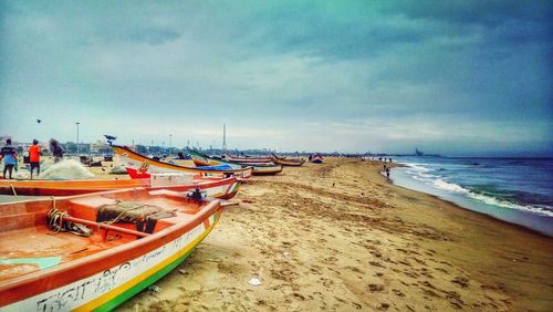 Scenic view of beach against cloudy sky