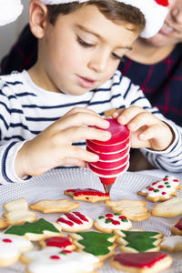 Boy preparing gingerbread cookies at home