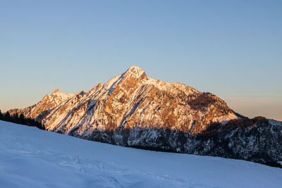 Scenic view of snowcapped mountain against clear sky