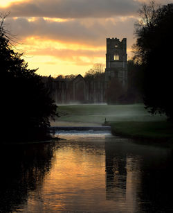 Scenic view of river at sunset