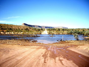 Scenic view of lake against clear blue sky