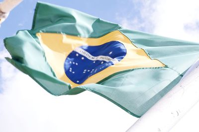 Low angle view of flag against blue sky