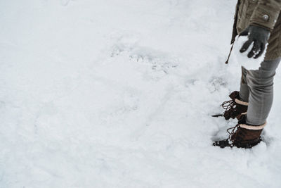 Low section of person on snow field