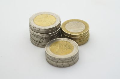 High angle view of coins on white background