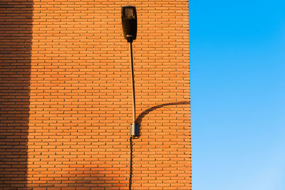 Low angle view of street light against building