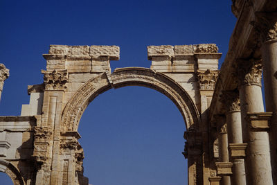 Low angle view of historical building against blue sky