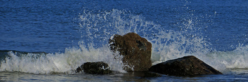 Waves splashing on rocks at shore