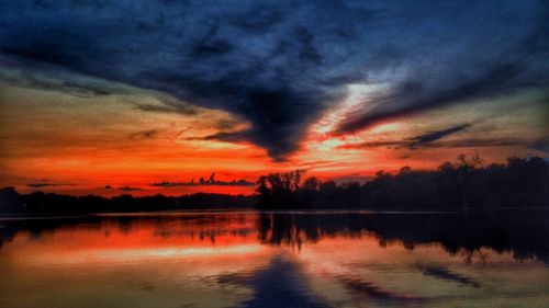 Scenic view of lake against cloudy sky