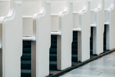 White benches in a row at church