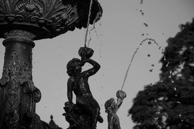 Low angle view of statue against sky