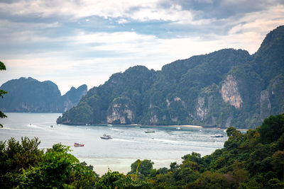 Scenic view of sea and mountains against sky