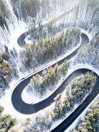 High angle view of road amidst trees during winter