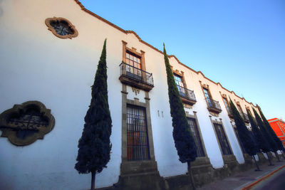 Low angle view of old building against clear blue sky