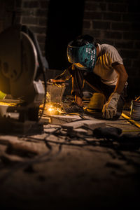 Man working at illuminated factory