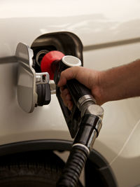 Cropped image of man filling petrol tank on car