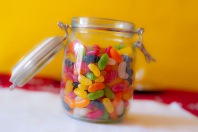 Close-up of candies in glass jar on table