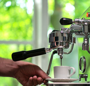 Close-up of hand holding coffee cup