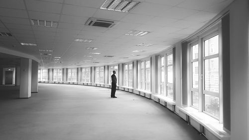 Rear view of man walking in corridor