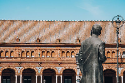 Low angle view of statue against building