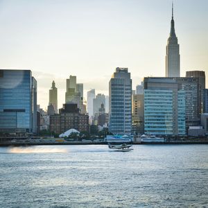 City at waterfront against clear sky