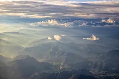 Aerial view of snowcapped mountains against sky