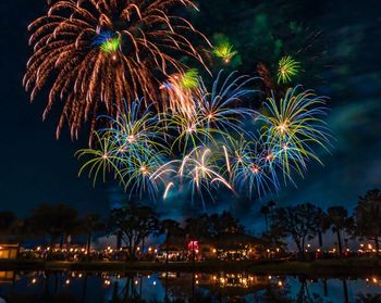 Low angle view of firework display at night