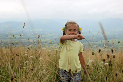 Portrait of boy standing on field