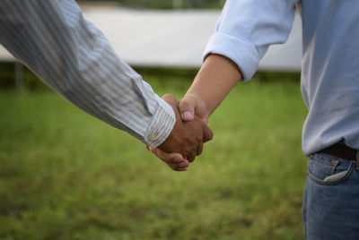 Close up people hands shake business partnership success,shake hand concept