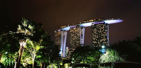 Low angle view of illuminated building against sky at night