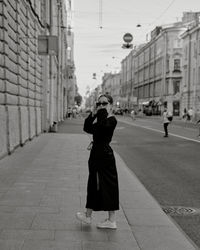 Rear view of woman walking on street in city