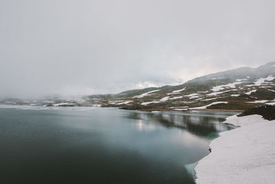 Scenic view of lake with mountains in background