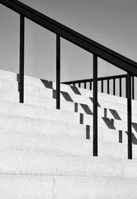 Shadow of railing on staircase against building