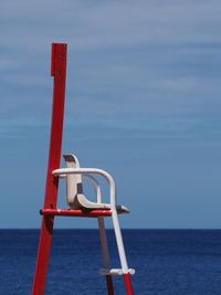 Lifeguard hut on sea against sky