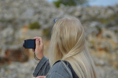 Rear view of photographer photographing