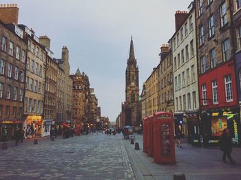 Street amidst buildings in city against sky