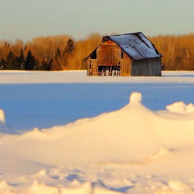 winter, cold temperature, snow, sunset, season, building exterior, built structure, architecture, house, tranquil scene, weather, landscape, beauty in nature, tranquility, field, orange color, nature, covering, scenics, sky