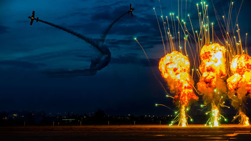 Low angle view of illuminated fireworks against sky at night