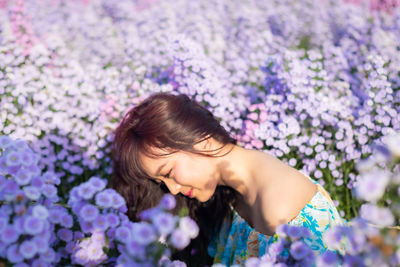 High angle view of woman on purple flowering plants