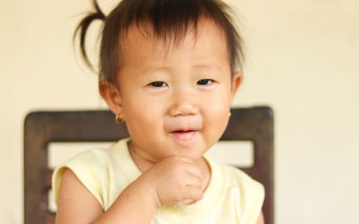 Close-up portrait of cute boy at home