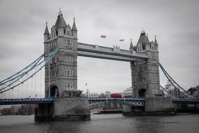 View of bridge over river against cloudy sky