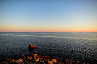 Scenic view of sea against clear sky during sunset